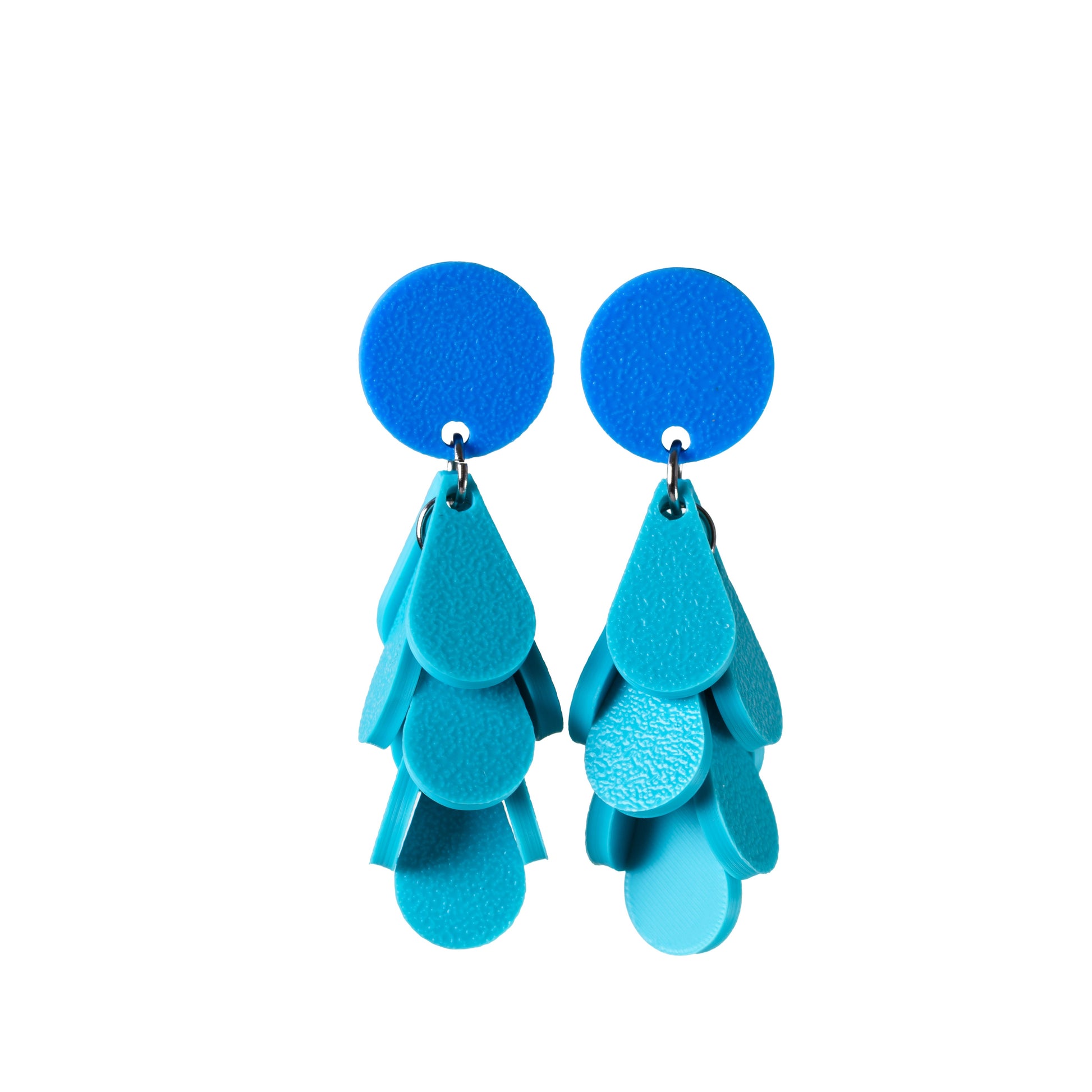 Blue and teal tiered earrings on a white background