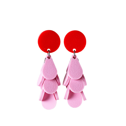 Red and pink earrings on a white background